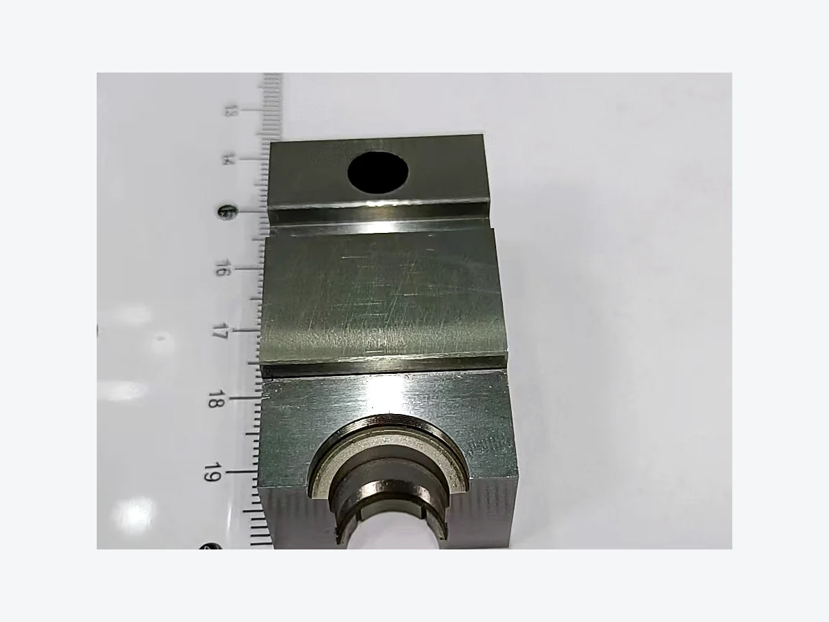 Machined steel profile block with a semicircular bore and fitted surfaces
